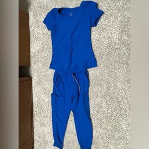Scrubs and Beyond. Color is royal blue. Size is Extra Small